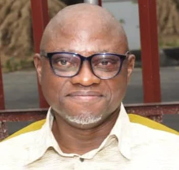 Portrait of Chris Echikwu, a Nigerian commodity market expert and former General Manager for Corporate Communications and Strategy at the Nigeria Commodity Exchange, photographed in a professional setting.