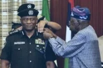 President Tinubu decorating his tribesman, Tunde Disu as acting IGP