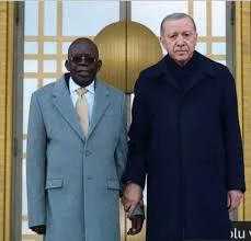President Tinubu being held by the wrist by his host, President Recep Tayyib Erdogan of Turkiye
