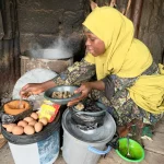 Maryam Ibrahim preparing and serving Dan Wake at her roadside food stand in Rigasa, Kaduna.