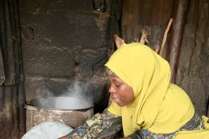 Maryam Ibrahim preparing and serving Dan Wake at her roadside food stand in Rigasa, Kaduna.
