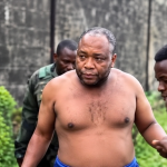 Tony Obina being escorted back to a prison facility in Liberia after reportedly being recaptured following a jailbreak.