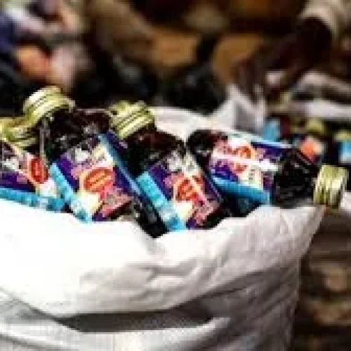 NDLEA operatives display 1,499 bottles of codeine-based cough syrup seized from a suspect in Kano during an anti-drug operation.