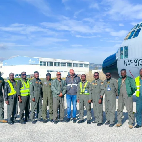 Crew of Nigerian Air Force C-130 transport aircraft at an airfield en route to OGMA maintenance facility in Portugal.