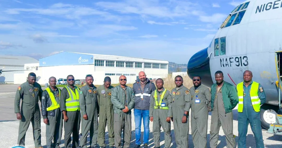 Crew of Nigerian Air Force C-130 transport aircraft at an airfield en route to OGMA maintenance facility in Portugal.